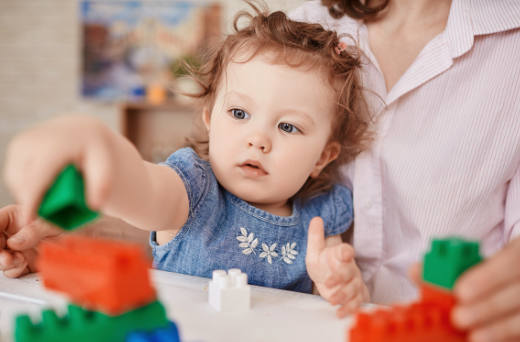Toddler playing with lego