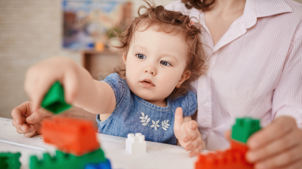 Toddler playing with lego